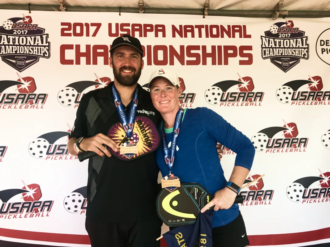 Sarah Ansboury with her mixed doubles partner and their medals
