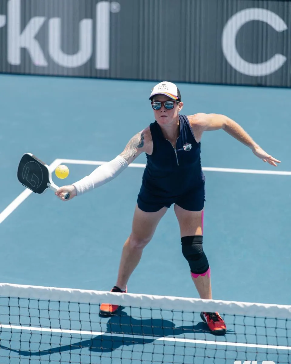 Sarah Ansboury competing in a doubles match